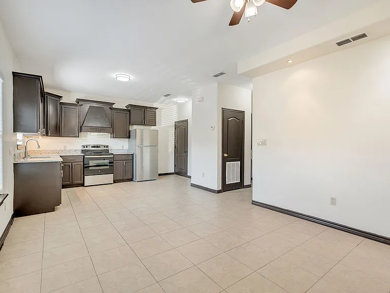 Luxurious kitchen showcasing exquisite tile flooring and refined cabinets at Merida Vista Apartments in Laredo, Texas