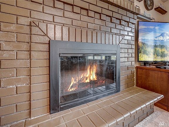 The all brick fireplace with hearth will keep the room toasty on chilly nights. 