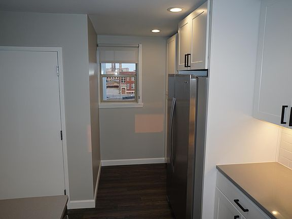 view of kitchen showing big fridge and pull out pantry