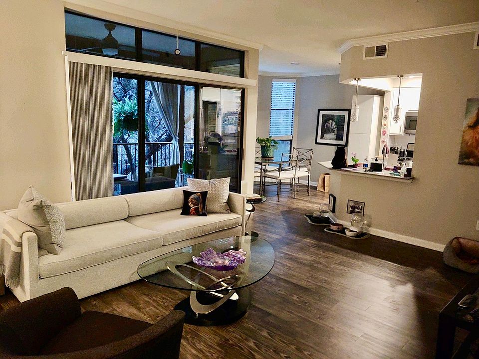 Living room with sliding glass doors to large patio. Additionally, features storage closet on patio.
