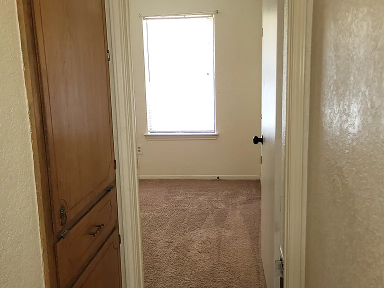 Hallway view of entering second bedroom