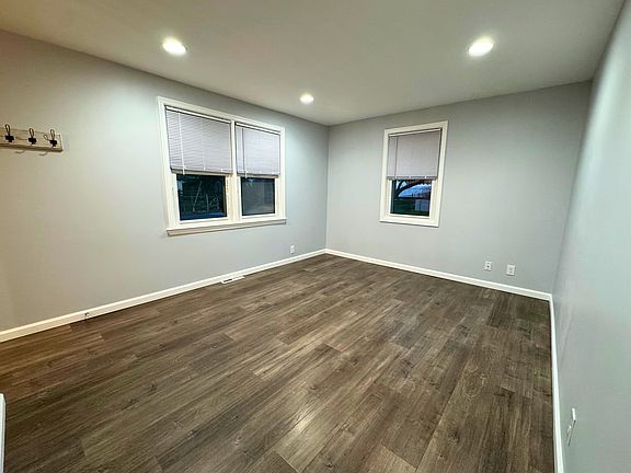 Living room with LVP and fresh paint, recessed lighting
