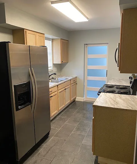 Kitchen stove, refrigerator, microwave, and garbage disposal