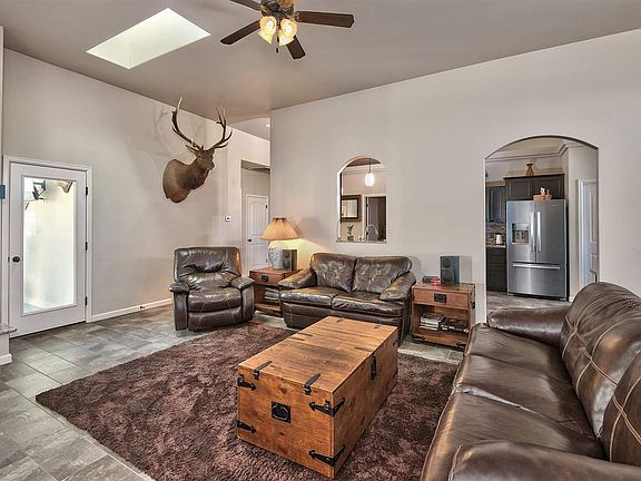 This home's spacious living room is paired to a large Colorado room and offers 2