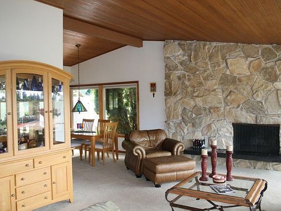 Large open living room-dining room with soaring cathedral ceilings.