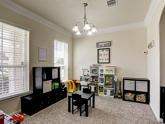 The Dining/Flex room has crown molding, double windows that overlook the covered front porch and features crown molding.