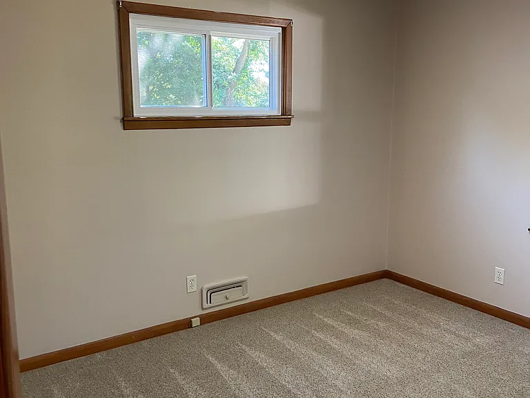 Bedroom 3 at front of home with fan & windows