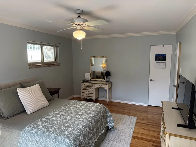 Master bedroom recently painted. Beautiful hardwood floors.