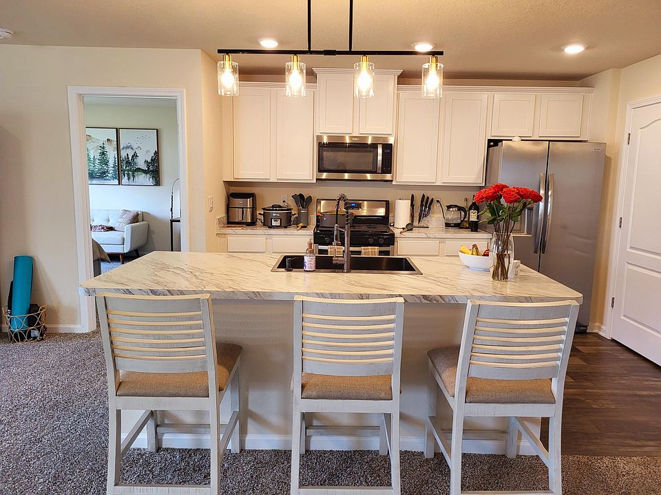 Fully Furnished Kitchen with Three Island Chairs