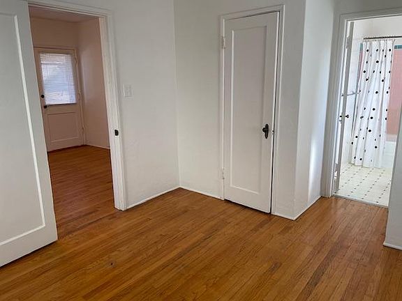 bedroom looking into living room and bathroom
