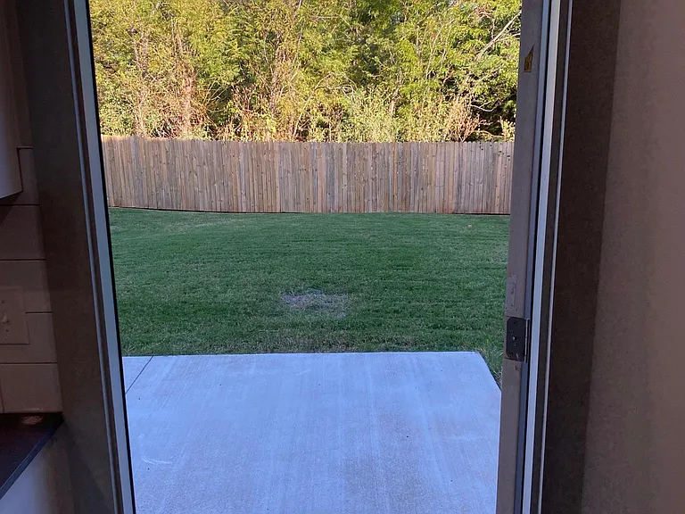 View from living room to the private backyard. Fully fenced and backs-up to a greenbelt....no neighbors and no street noise!