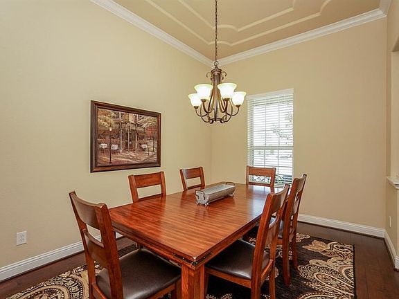 Formal dining room with wood floors.