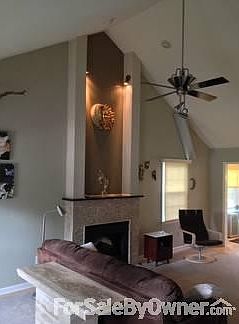 Vaulted ceilings with travertine fireplace with granite mantle.