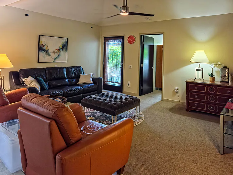 Living room is comfortable and adjacent to open kitchen area.