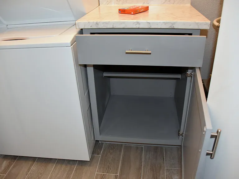 Vanity cabinet for folding clothes and storing laundry products