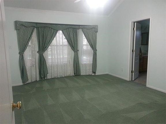 Master has ceiling fan, fresh paint, extra lighting and beautiful drapery.