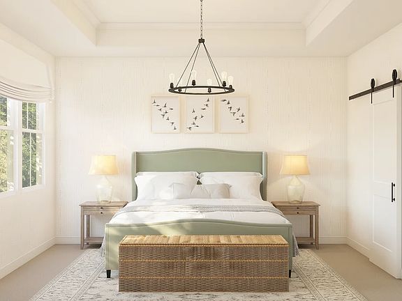 Primary suite with crown moulding and chandelier