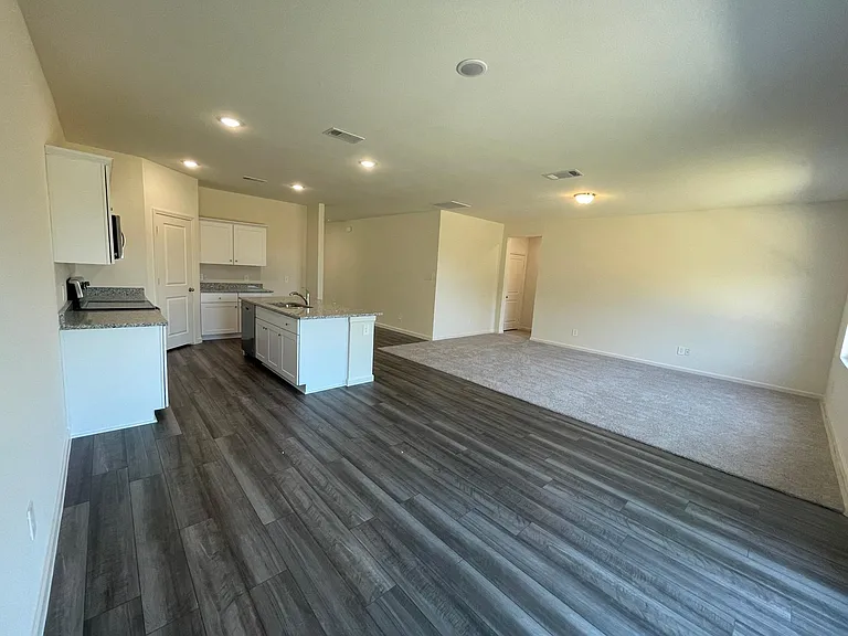 Open floor plan with granite and stainless steel appliances in the kitchen