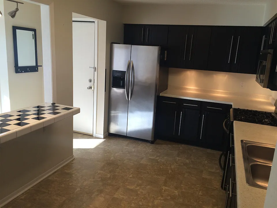 Open kitchen w/stainless steel appliances.