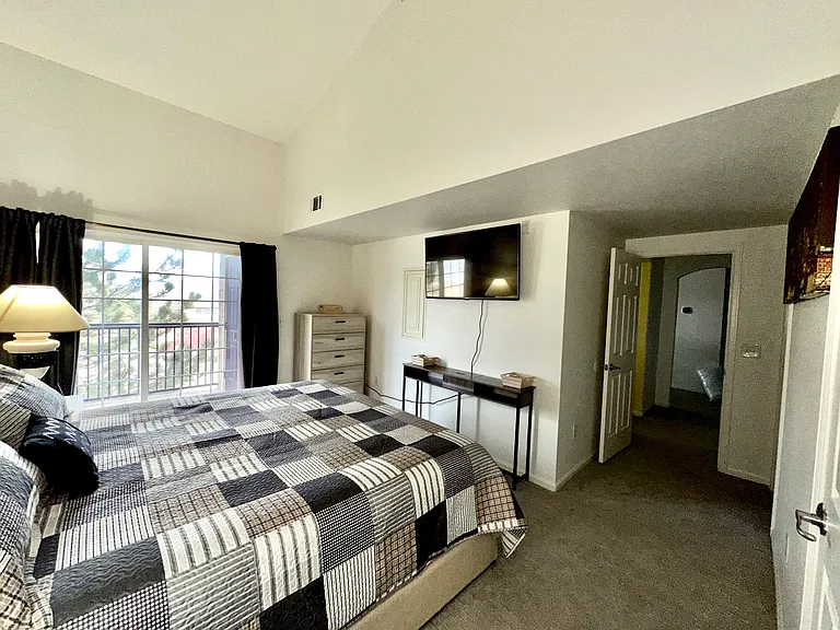 Master bedroom. King size bed, walk- in closet, TV, balcony.
