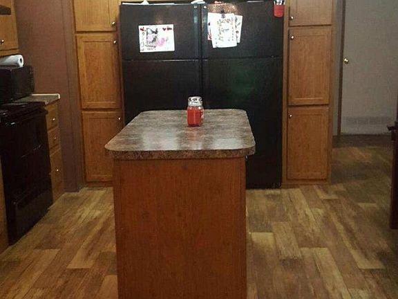 Kitchen with island and double fridge