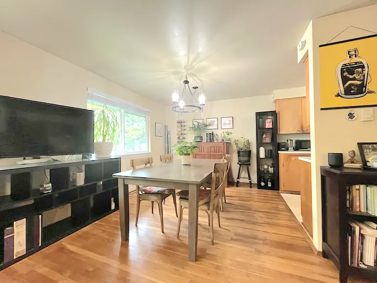 Dining table area leads to kitchen on right side