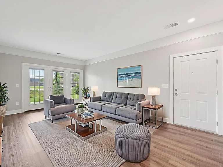Dooley's Orchard unit showing a living room with a grey couch and a coffee table.