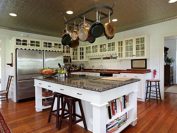 KITCHEN: (12'x19') Pine hardwood floors. Stenciled faux tin ceiling. Granite island with electric stove. Side -by-side GE refrigerator and freezer. Hotpoint dishwasher and ice maker. Built in cabinets with glass faces. Recessed lighting.
