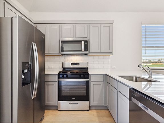 Kitchen in the Ash home plan by Trophy Signature Homes - REPRESENTATIVE PHOTO