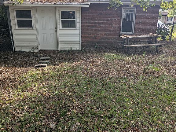 Back entrance with utility room and washer and dryer