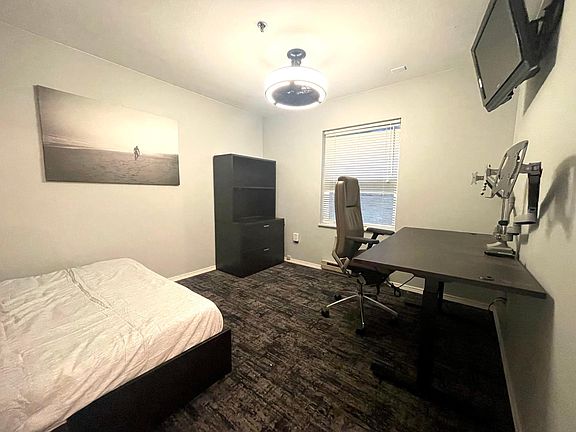 Spare Bedroom includes a brand new full size bed with a memory foam mattress, big desk that rises and drops, dual monitors with wireless keyboard and mouse, wireless printer, and a ceiling fan for those hot days.