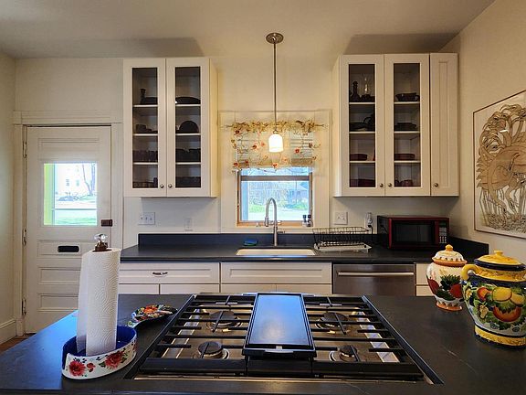 Kitchen With Counter Mount Gas Stove ,Quartz Countertops, And Private Entrance