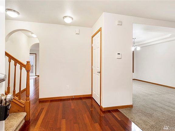 BRAZILLIAN CHERRY WOOD FLOORS AT ENTRY AND HALL TO KITCHEN . NEW CARPETING IN LIVING ROOM AND FORMAL DINING TO THE RIGHT