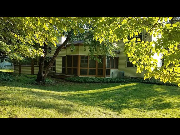 A view of the screened-in porch from the back yard