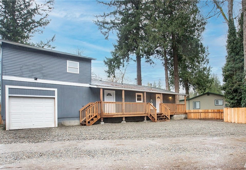 Front of home with plenty of parking for guests and brand new fence. Look at that large front porch! 2 Entrance options to your home, door on left is to mud room, door on right enters to kitchen/dining area. 
