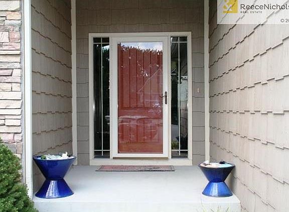 Covered front entry leads to open great room with kitchen and dining area.