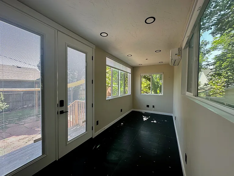 French door with one operable/locking panel, and wide double-pane tempered glass windows with argon insulation_designed for maximum energy efficiency and comfort