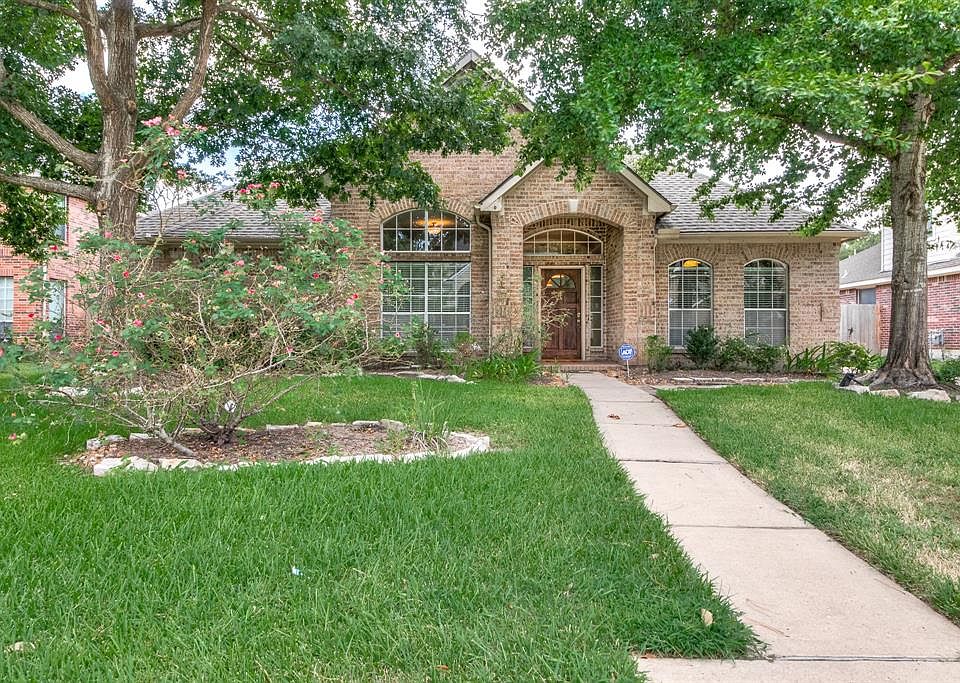 Mature trees with long walkway welcomes you home.