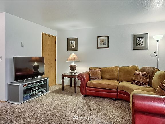View of living room with coat closet. Nice carpeting throughout first floor. 