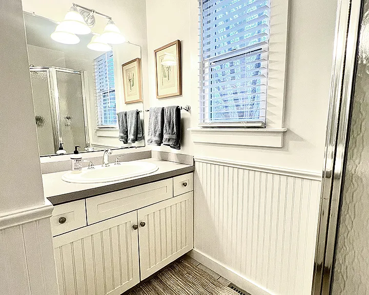 First floor bathroom, shower, beach towel closet, and laundry facilities.