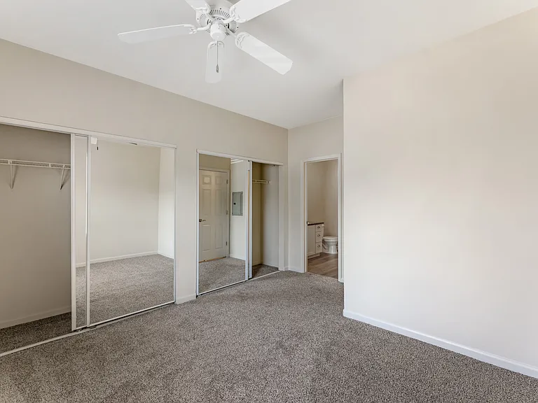Bedrooms at Ascent at the Galleria come with cozy carpeting and ceiling fans, providing comfort and a relaxing atmosphere in every home.