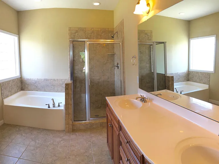 Master Bathroom features double vanity, jacuzzi tub and larg