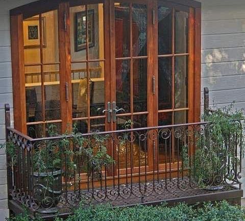 Juliet balcony off dining room custom mahogany french doors.