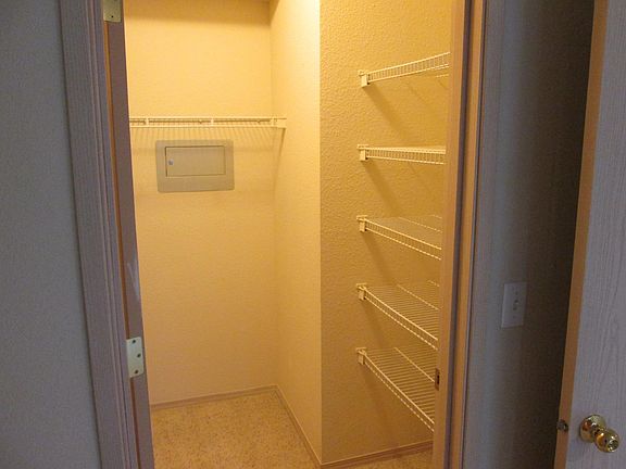 Walk in closet with built in shelves.