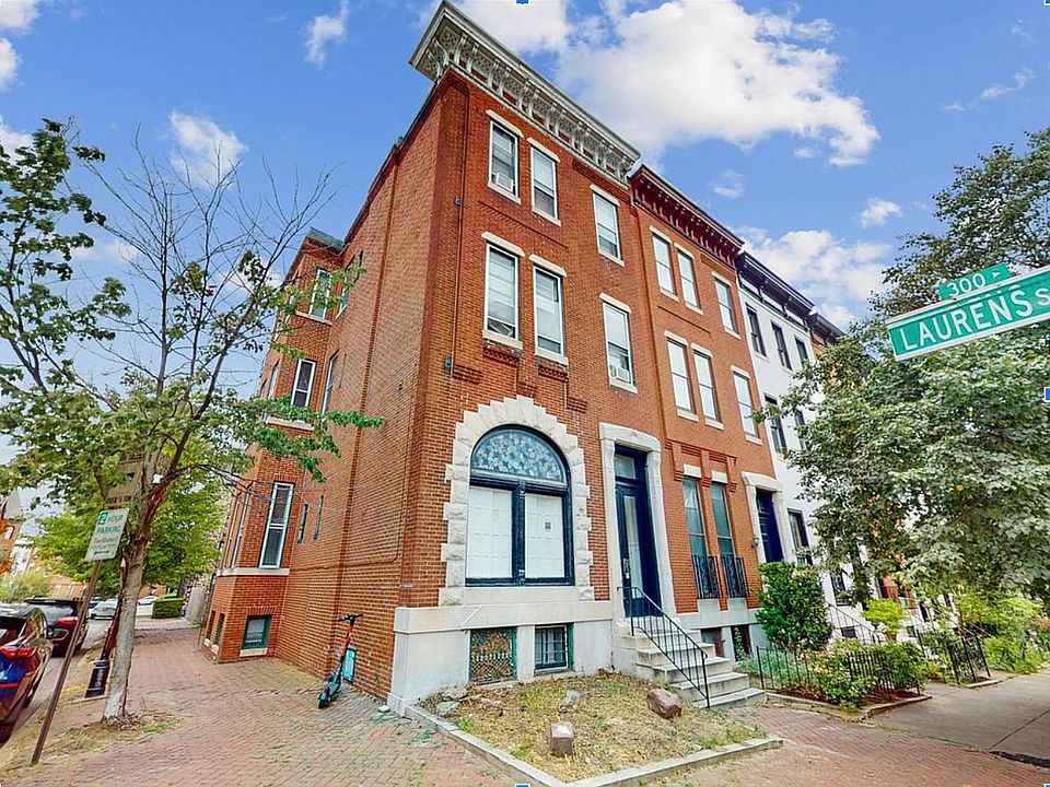 Beautiful corner building with stained-glass window and corniche. (New landscaping coming soon.)