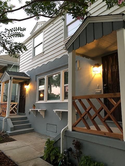 1930 vintage charm, restored and modernized for your comfort. Mature shade trees frame the duplex. 2924 is the top level unit.