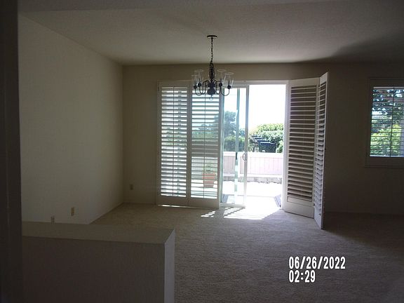 view from entry hall through dining room to patio looking to ocean beyond
