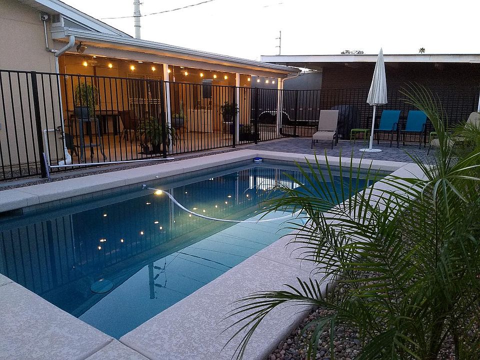 Pool with newly installed heater, surrounded by safety fence. Perfect spot to relax.