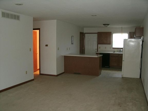 living/dining combo with new carpet and woodlike flooring