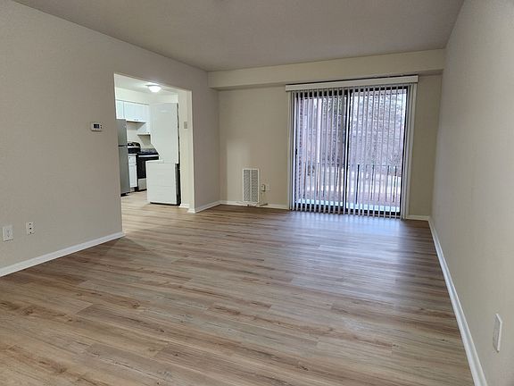 Living space with lots of natural light. New flooring, new paint.